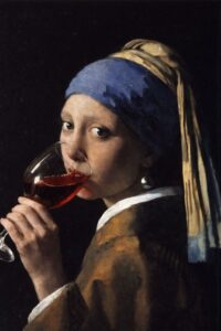 woman with a pearl earing drinking wine