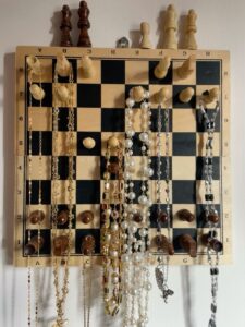 Organize your jewelry with thrifted items and hang them on the wall like home decor