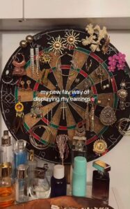 Organize your jewelry with thrifted items and hang them on the wall like home decor