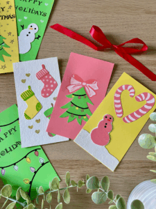 Custom holiday cards featuring christmas tree, stockings and snowman, perfect for date night christmas craft by artsy drawings brianna eisman